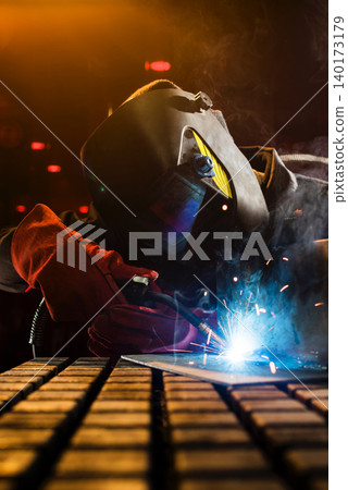Masterful welding at night reveals shining sparks Masterful welding at night reveals shining sparks 140173179