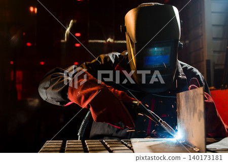 Crafting metal dreams under glowing sparks Crafting metal dreams under glowing sparks 140173181