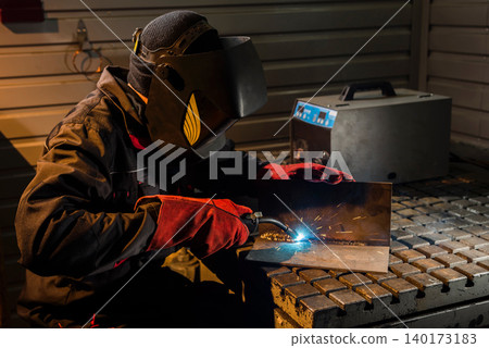Mastering metalwork in a dimly lit workshop Mastering metalwork in a dimly lit workshop 140173183