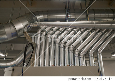 Industrial pipes create a complex network overhead 140173212