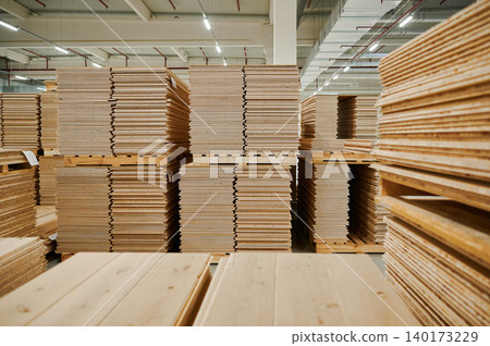 Stacks of unfinished wood in a warehouse space Stacks of unfinished wood in a warehouse space 140173229
