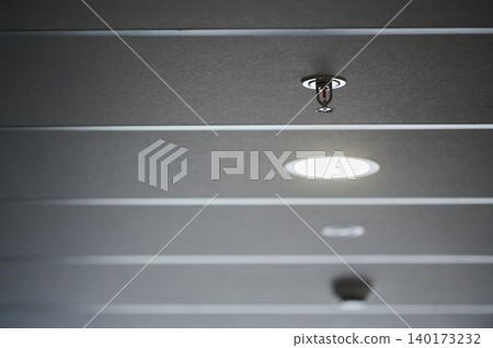 Sprinkler and light blend in modern ceiling design Sprinkler and light blend in modern ceiling design 140173232