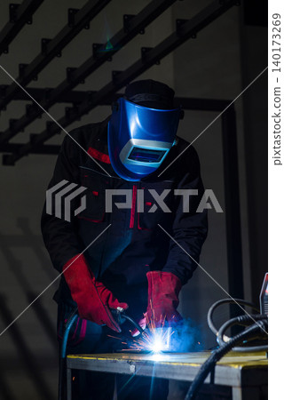 Sparks fly during welding in a dim workshop Sparks fly during welding in a dim workshop 140173269