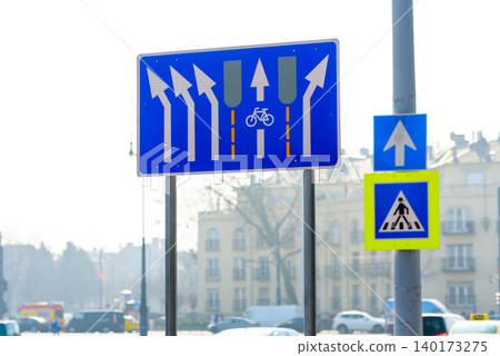 Road signs guide cyclists through busy city lane 140173275