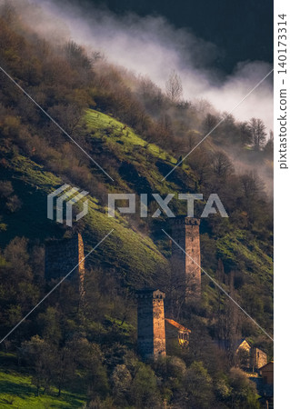 Misty hills cloak ancient stone towers, Georgia. Vertical view. Misty hills cloak ancient stone towers, Georgia. Vertical view. 140173314