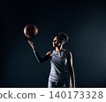 Young sportswoman in uniform tosses a basketball in the studio 140173328