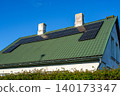 Residential rooftop solar panel system installed on metal roof for renewable energy generation home 140173347