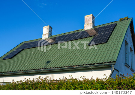 Residential rooftop solar panel system installed on metal roof for renewable energy generation home Residential rooftop solar panel system installed on metal roof for renewable energy generation home 140173347
