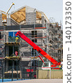 Multi family residential building construction with crane scaffolding and timber roof structure 140173350