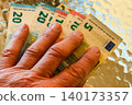 Hand holding euro banknotes illustrating personal finance budgeting expenses and cash management 140173357