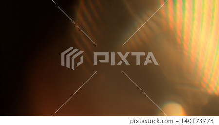 Abstract RGB prism lens flare with colorful light refraction and optical distortion. Creative cinematic background suitable for visual effects, overlays and modern digital design. 140173773