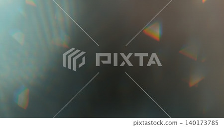 Abstract RGB prism lens flare with colorful light refraction and optical distortion. Creative cinematic background suitable for visual effects, overlays and modern digital design. 140173785
