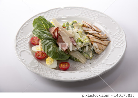 Fresh and vibrant salad with grilled chicken and creamy dressing served elegantly on a plate 140173835