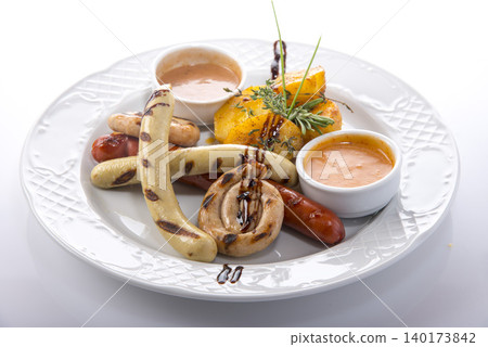 Flavorful assortment of grilled sausages and tropical sides served with rich sauces Flavorful assortment of grilled sausages and tropical sides served with rich sauces 140173842