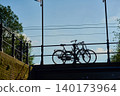 Bicycles Resting on a Bridge With Vibrant Blue Skies in Charming City Center 140173964
