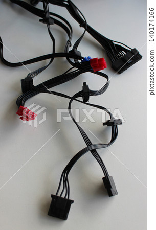 Variety Plugs Of Computer Power Supply Cords On White Table Variety Plugs Of Computer Power Supply Cords On White Table 140174166