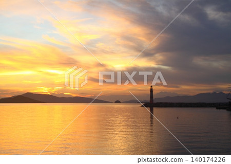 Seascape at sunshine. Lighthouse and sailings on the coast. Seaside town of Turgutreis and spectacular sunshine Seascape at sunshine. Lighthouse and sailings on the coast. Seaside town of Turgutreis and spectacular sunshine 140174226