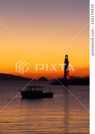 Seascape at sunshine. Lighthouse and sailings on the coast. Seaside town of Turgutreis and spectacular sunshine Seascape at sunshine. Lighthouse and sailings on the coast. Seaside town of Turgutreis and spectacular sunshine 140174458