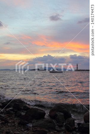 Seascape at sunshine. Lighthouse and sailings on the coast. Seaside town of Turgutreis and spectacular sunshine Seascape at sunshine. Lighthouse and sailings on the coast. Seaside town of Turgutreis and spectacular sunshine 140174473