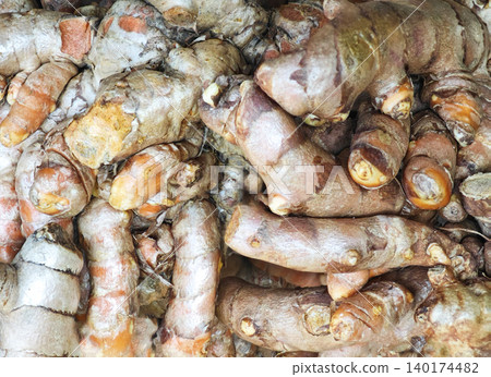 Fresh orange turmeric roots, a high-quality natural herbal ingredient.. Fresh orange turmeric roots, a high-quality natural herbal ingredient.. 140174482