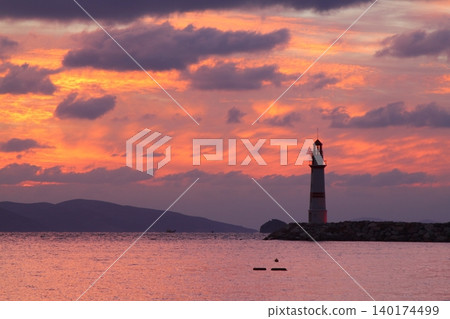 Seascape at sunshine. Lighthouse and sailings on the coast. Seaside town of Turgutreis and spectacular sunshine 140174499