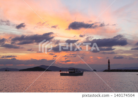 Seascape at sunshine. Lighthouse and sailings on the coast. Seaside town of Turgutreis and spectacular sunshine 140174504