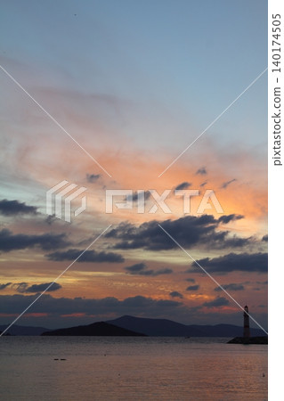 Seascape at sunshine. Lighthouse and sailings on the coast. Seaside town of Turgutreis and spectacular sunshine 140174505