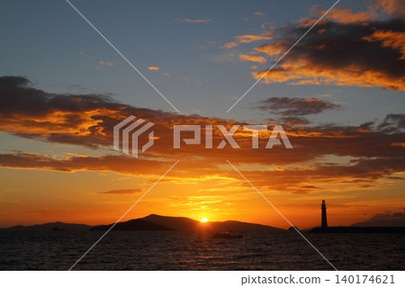 Seascape at sunshine. Lighthouse and sailings on the coast. Seaside town of Turgutreis and spectacular sunshine Seascape at sunshine. Lighthouse and sailings on the coast. Seaside town of Turgutreis and spectacular sunshine 140174621