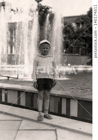 Young boy posing near a decorative fountain in Crimea during a family trip in 1971 140174811