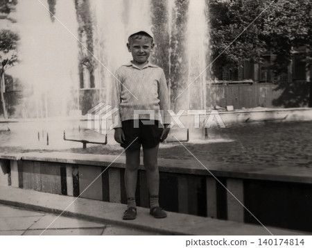 Young boy standing beside a fountain during a family trip in Crimea in 1971 Young boy standing beside a fountain during a family trip in Crimea in 1971 140174814