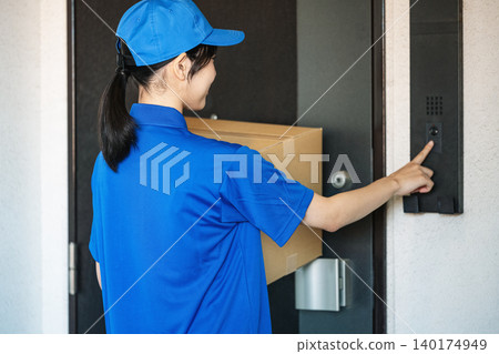 A female delivery person rings the doorbell at the front door. A female delivery person rings the doorbell at the front door. 140174949