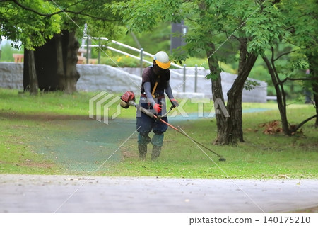 Image of grass cutting work in the park Image of grass cutting work in the park 140175210