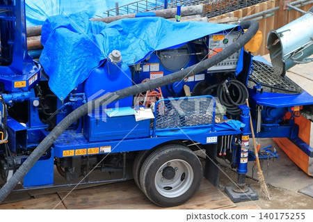 Image of a concrete pump truck and mixer truck during concrete pouring. Image of a concrete pump truck and mixer truck during concrete pouring. 140175255