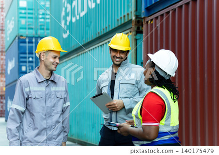 Diverse logistics team discussing cargo operations with digital devices at container shipping yard, highlighting teamwork, supply chain coordination, workplace communication and modern freight 140175479
