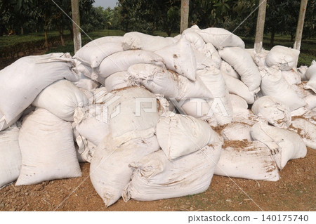 pile of white sacks with fertilizer on farm pile of white sacks with fertilizer on farm 140175740