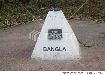 concrete boundary pillar marking the international border 140175792