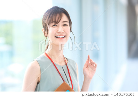 A young businesswoman smiles, her face showing an idea. A young businesswoman smiles, her face showing an idea. 140176105