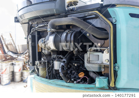 Inside the engine compartment of a small construction machine Inside the engine compartment of a small construction machine 140177291
