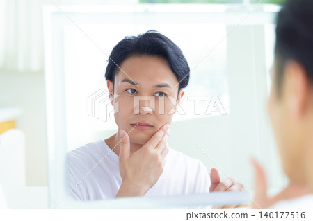 Beauty image: Middle-aged man looking in the mirror Beauty image: Middle-aged man looking in the mirror 140177516