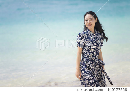 Young woman walking on the seaside Young woman walking on the seaside 140177838