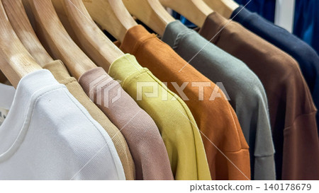 Row of colorful T- shirts hanging on Row of colorful T- shirts hanging on 140178679