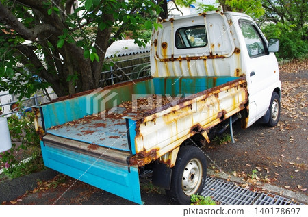 An old light truck with severe red rust. An old light truck with severe red rust. 140178697