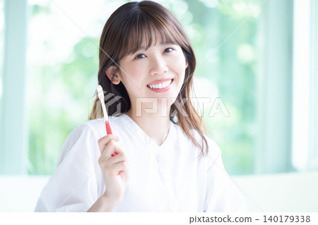 Oral care: A woman brushing her teeth. Oral care: A woman brushing her teeth. 140179338