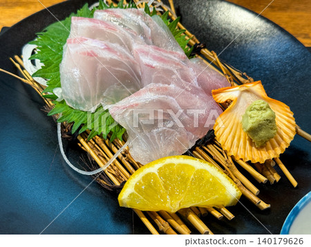 Japanese dish of sea bream sashimi served with wasabi. 140179626