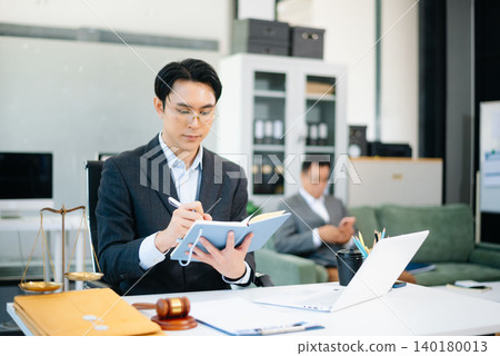 Asian business team and lawyers discussing contract papers sitting at the table. Concepts of law, advice, legal services. Asian business team and lawyers discussing contract papers sitting at the table. Concepts of law, advice, legal services. 140180013