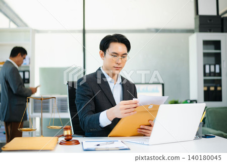 Asian business team and lawyers discussing contract papers sitting at the table. Concepts of law, advice, legal services. Asian business team and lawyers discussing contract papers sitting at the table. Concepts of law, advice, legal services. 140180045