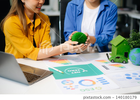 Business team meeting for ESG, net zero, and sustainability goals. Green energy, climate action, and eco-friendly strategies Business team meeting for ESG, net zero, and sustainability goals. Green energy, climate action, and eco-friendly strategies 140180179