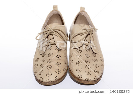 Beige women's summer shoes on a white background Beige women's summer shoes on a white background 140180275