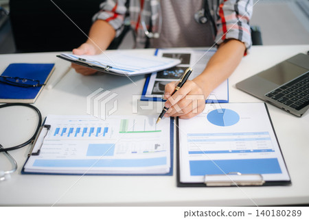 Medical technology concept. Doctor working with mobile phone and stethoscope and digital tablet laptop in modern office Medical technology concept. Doctor working with mobile phone and stethoscope and digital tablet laptop in modern office 140180289