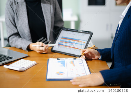 Business team collaboration discussing working analyzing with financial data and marketing growth report graph in team, presentation and digital tablet, laptop. 140180528